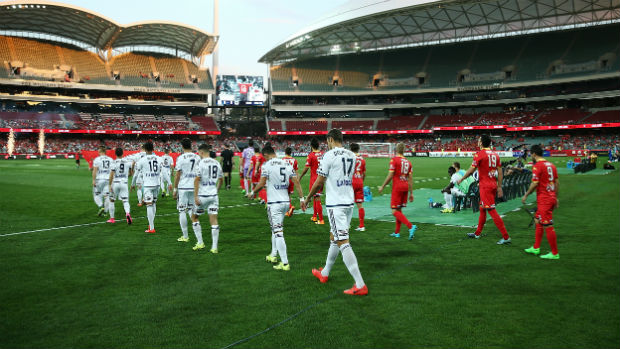 Adelaide United and Melbourne Victory players enter the Adelaide Oval for their Round 1 clash.