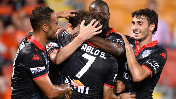 Adelaide United players celebrate after taking the lead against Brisbane Roar at Suncorp Stadium.