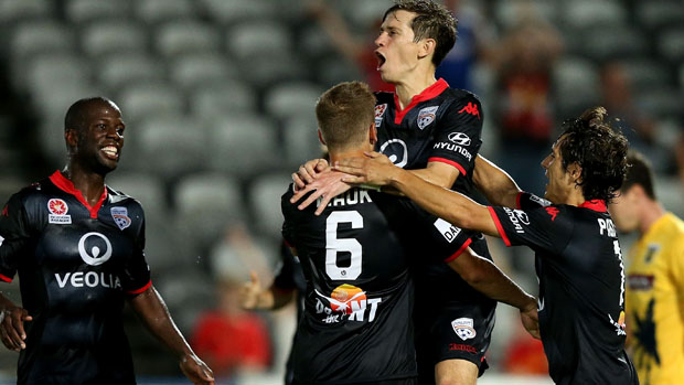Reds winger Craig Goodwin celebrates a goal with his Adelaide United teammates.
