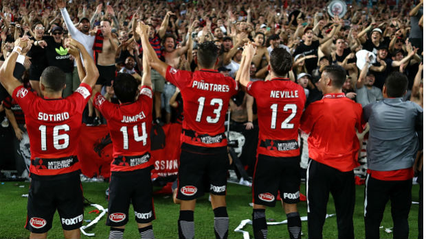 Wanderers players celebrate their Sydney Derby win with their fans at ANZ Stadium on Saturday night.