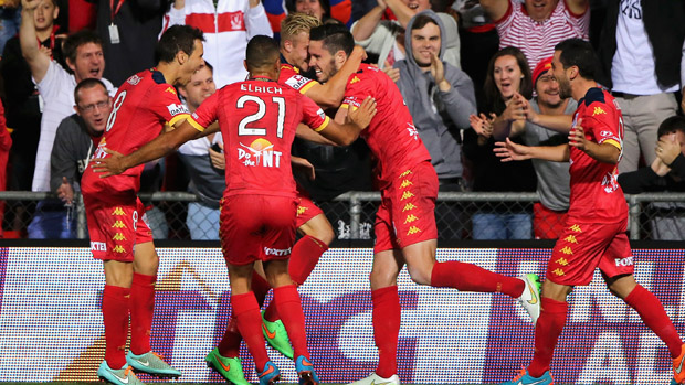 Reds players celebrate a goal in their 2-2 draw with Victory.