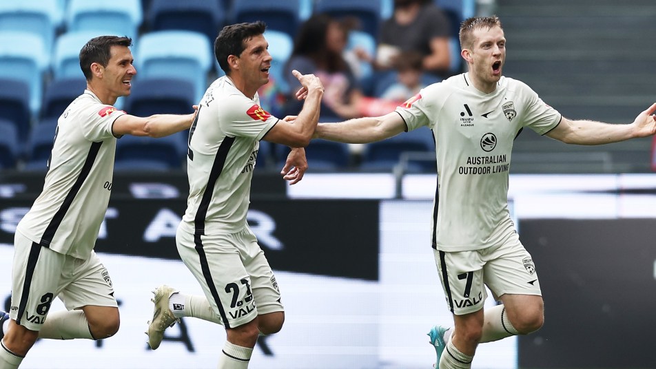 Ryan Kitto celebrates with teammates after putting the Reds 1-0 up against Sydney FC in Round 3.