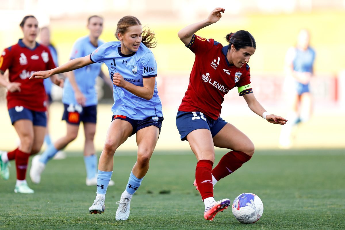Adriana Taranto of Adelaide United competes with Madeleine Caspers of Sydney FC at Sydney Olympic Park Athletic Centre.