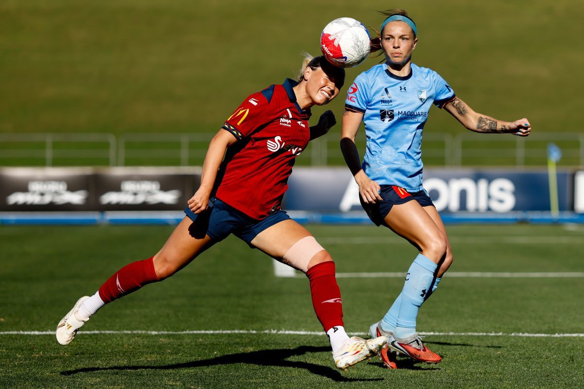 Holly Murray of Adelaide United heads the ball at Sydney Olympic Park Athletic Centre.