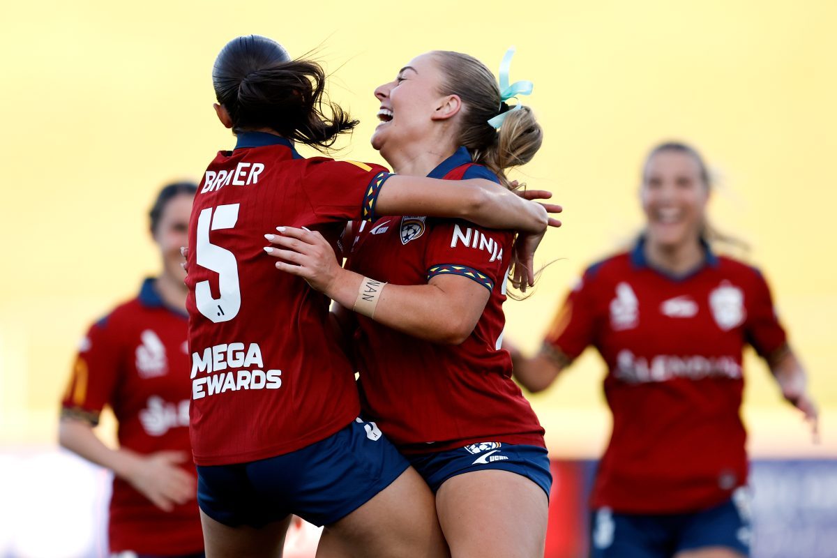 India Breier of Adelaide United celebrates scoring a goal with team mate Lara Gooch at Sydney Olympic Park Athletic Centre.