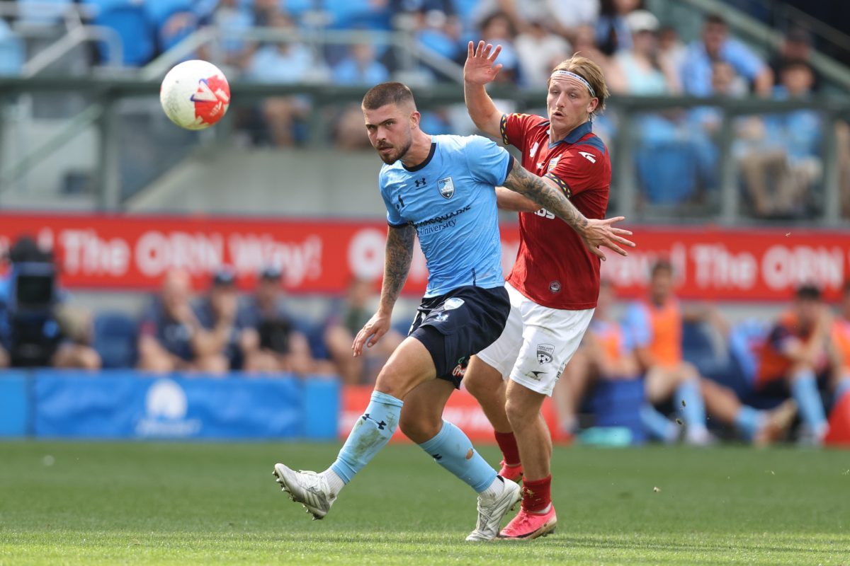 Alex Popovic of Sydney FC and Brody Burkitt of Adelaide United compete for the ball at Allianz Stadium.