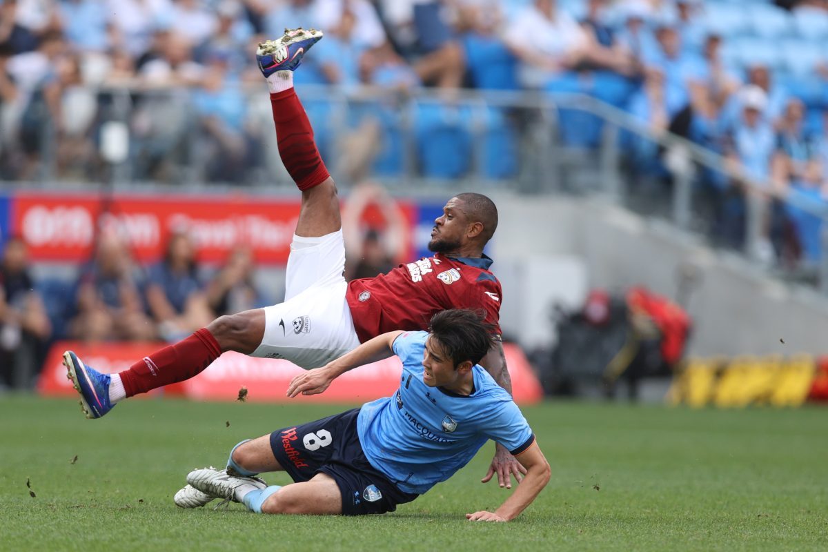 Anselmo de Moraes of Adelaide United is challenged by Wataru Kamijo of Sydney FC at Allianz Stadium.